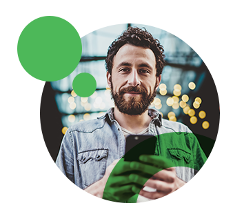 man looking at camera and using phone